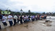 Residents cross a flooded street after a massive landslide and flood in Trujillo, northern Peru, March 17, 2017. REUTERS/Douglas Juarez 
