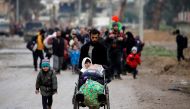 Displaced Iraqi people from different areas in Mosul flee their homes after clashes to reach safe areas, as Iraqi forces battle with Islamic State militants in the city of Mosul, Iraq March 18, 2017. REUTERS/Youssef Boudlal