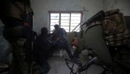 Iraqi forces, consisting of the Iraqi federal police and the elite Rapid Response Division, fires towards Islamic State (IS) group jihadists as they advance in the Old City in western Mosul on March 19, 2017, during the offensive to retake the city from I