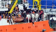 Would be immigrants wait to disembark in the port of Catania, on the island of Sicily on March 21, 2017 from the ship 