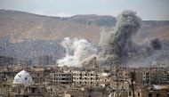 A general view show smoke rising from buildings following an air strike on Jobar, a rebel-held district on the eastern outskirts of the Syrian capital Damascus, on March 21, 2017. AFP / Ammar SULEIMAN