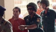 Cambodian Oeuth Ang (2nd L), an unemployed ex-soldier who calls himself 