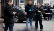 Investigators inspect the body of Denis Voronenkov, a former lawmaker of the Russian State Duma, who was shot dead, in central Kiev, Ukraine March 23, 2017. REUTERS/Valentyn Ogirenko 
