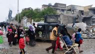 Iraqi civilians evacuate the area as the Iraqi counter-terrorism service (CTS) advance towards the Yabasat neighbourhood on March 23, 2017 during their ongoing offensive to push Islamic State (IS) jihadists out of Mosul. About 600,000 people remain in the