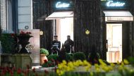 Monaco's police officers stand guard in front of the Cartier jewellery boutique after it was robbed in downtown Monaco on March 25, 2017. One robber was arrested by Police, as two remained on the run.  AFP /  YANN COATSALIOU
