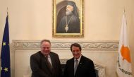 Cypriot President Nicos Anastasiades (R) and Greek Foreign Minister Nikos Kotzias shake hands during a meeting at the presidential palace in Nicosia, Cyprus March 27, 2017. REUTERS/Yiannis Kourtoglou
