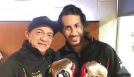 Qatar's first professional boxer Sheikh Fahad Khalid Al Thani (right) poses for a photograph with his trainer Ishmel Antonio Salas.