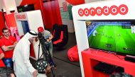 Qatar University students watch a football match on television at the Student Entertaining Majlis.