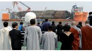 Family members of victims onboard the sunken ferry Sewol and religious people look on during a memorial ceremony at the sea off Jindo, South Korea, March 28, 2017. Yonhap via REUTERS.