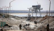 Members of the US-backed Syrian Democratic Forces (SDF), made up of an alliance of Arab and Kurdish fighters, inspect the Tabqa dam on March 27, 2017, which has been recently partially recaptured, as part of their battle for the jihadists' stronghold in n
