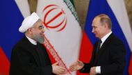 Russian President Vladimir Putin (R) shakes hands with his Iranian counterpart Hassan Rouhani during a joint press conference following their meeting at the Kremlin in Moscow on March 28, 2017.  AFP / Pool / Sergei Karpukhin