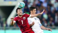 Qatari midfielder Rodrigo Tabata (left) heads the ball during the 2018 FIFA World Cup qualifying game against Uzbekistan at Bunyodkor Stadium in Uzbekistan yesterday.