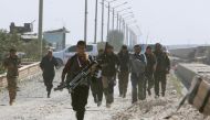 Engineers, journalists and Syrian Democratic Forces (SDF) fighters run for cover after Islamic State shelled positions held by the SDF at the Tabqa Dam on the Euphrates River, Syria March 29, 2017. REUTERS/Rodi Said 