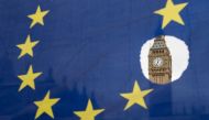 A pro-remain protester holds up an EU flag with one of the stars symbolically cut out in front of the Houses of Parliament shortly after British Prime Minister Theresa May announced to the House of Commons that Article 50 had been triggered in London on M