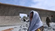 Syrian Democratic Forces (SDF) fighters walk near rubble of damaged houses east of Raqqa city, Syria March 26, 2017. REUTERS/Rodi Said