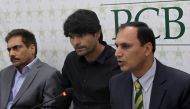 Pakistan Cricket Board (PCB) anti-corruption unit chief Mohammad Azam (R) is flanked by suspended cricketer Mohammad Irfan (C) as he speaks to media in Lahore on March 29, 2017. Pakistan have suspended fast bowler Mohammad Irfan for one year and fined him