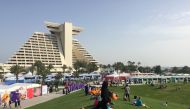 Festival visitors enjoy the vast green area of the Hotel Park yesterday afternoon.  Pic: Raynald C Rivera / The Peninsula
