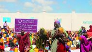 Women and children receiving aid supplied by Qatar Charity in drought-hit Somalia.
