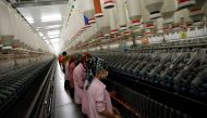 Workers are seen in front of a product line in a textile factory in Diyarbakir March 21, 2017. Picture taken March 21, 2017. REUTERS/Umit Bektas
