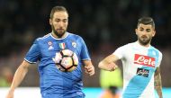 Juventus' forward from Argentina Gonzalo Higuain (L) fights for the ball with Napoli's Albanian defender Elseid Hysaj during the Italian Serie A football match SSC Napoli vs Juventus FC on April 2, 2017 at the San Paolo Stadium. AFP / CARLO HERMANN