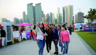 Visitors take a groufie at the Qatar International Food Festival at the Hotel Park which provides an ideal backdrop with its scenic view of the West Bay Towers and the Doha Corniche. Pic: Salim Matramkot / The Peninsula
