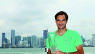 Roger Federer of Switzerland poses in front of the Miami Skyline after defeating Rafael Nadal of Spain during the Men's Final and day 14 of the Miami Open at Crandon Park Tennis Center on April 2, 2017 in Key Biscayne, Florida. Al Bello/Getty Images/AFP