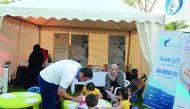 QCS officials educating children about health food and exercise.