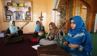 In this photograph taken on February 25, 2017, Kashmiri Muslim girls play instruments and sing Sufi music under the tutelage of music teacher, Muhammad Yaqoob Sheikh, on the outskirts of Srinagar. AFP 