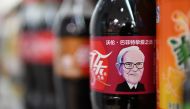 A Cherry Coke bottle featuring an image of US investor Warren Buffet is seen on a shelf at a convenience store in Beijing on April 5, 2017. AFP / Greg Baker