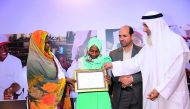Qatar Charity officials awarding a winner of one of the competitions organised to mark International Day of Orphans.