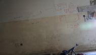 A machine gun is seen on the floor next to a map drawn to show distances, on the wall of a sniper's nest in a building controlled by Iraqi forces fighting the Islamic State in Mosul, Iraq, April 6, 2017. REUTERS/Andres Martinez Casares