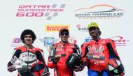 Nasser Al Malki (centre), Abdulla Al Qubaisi (left) and Ali Al Shammari pose after the second race at the Losail International Circuit.   