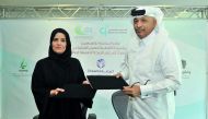 Amal bint Abdullatif Al Mannai (left), CEO of Qatar Foundation for Social Work; and  Hassan bin Abdullah Al Ghanim, Deputy Chairman of Mental Health Friends Association Weyak; exchange documents after signing an MoU at Tornado Tower recently.  Pic: Baher 