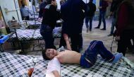 A Syrian child receives treatment at a makeshift clinic following reported air strikes by government forces in the rebel-held town of Douma, on the eastern outskirts of Damascus, yesterday.