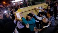 Graphic content / Egyptian Christians carry a coffin during the late night funeral of the victims of a blast which killed worshippers attending Palm Sunday mass at the Mar Girgis Coptic Orthodox Church in the Nile Delta City of Tanta, 120 kilometres (75 m