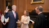 Chief Justice of the United States John Roberts (R) administers the constitutional oath to judge Neil Gorsuch, as his wife Louise Gorsuch holds the bible during a private ceremony at the Supreme Court in Washington, U.S., April 10, 2017. Courtesy Supreme 