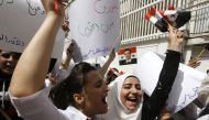 Syrian protestors take part in a demonstration outside the United Nation's (UN) office in the capital Damascus, on April 11, 2017, in support of their country's President Bashar al-Assad.  AFP / Louai Beshara
