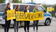Supporters of German first division Bundesliga football club Borussia Dortmund hold up posters reading 