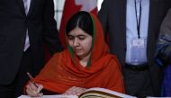 Malala Yousafzai signs a guest book at Parliament Hill in Ottawa, Ontario, April 12, 2017. Malala Yousafzai will receive an honorary Canadian citizenship. Nobel Peace laureate Malala Yousafzai becomes only the sixth person to receive honorary Canadian cit