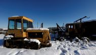 Abandoned tractors are seen at a decommissioned placer mine in the settlement of Nelkan, Republic of Sakha (Yakutia), Russia, March 22, 2017. REUTERS/Sergei Karpukhin