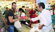 Booklets on food safety being distributed to customers as part of the Gulf Food Day, yesterday.