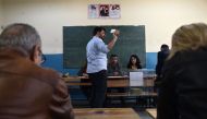 Electoral official count ballots after the polls closed during the referendum on expanding the powers of the president on April 16, 2017 at a polling station in Istanbul.  AFP / OZAN KOSE
