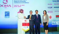 Abdulaziz Al Mass, Vice-President Commercial and Marketing of HIA (left) handing over the flag to Kenichi Fukaya, Senior Executive Adviser of Narita International Airport in the presence of Futoshi Osada, Executive Vice-President of Narita International A