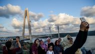REPRESENTATIVE IMAGE: People take selfies as they pose next to the Yavuz Sultan Selim bridge on August 26, 2016 in Istanbul during the inauguration of the bridge (AFP) 