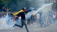 Demonstrators clash with the riot police during a protest against Venezuelan President Nicolas Maduro, in Caracas on April 20, 2017.  AFP / Federico PARRA