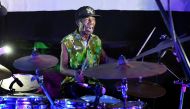 Ivorian jazz drummer Paco Sery performing on a stage during an homage to the victims of March 13, 2016 terror attack at the resort of Grand Bassam, east of Abidjan on March 12, 2017. AFP / Sia Kambou