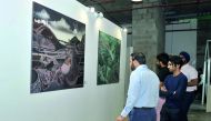 Visitors looking at the art works at the Currents exhibition.
