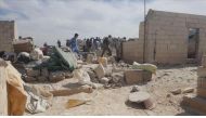 Syrians inspect debris after airstrikes in Idlib refugee camp on April 26, 2017. (Muhammed Karkas - Anadolu Agency).
