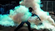 A member of the National Guard cracks down on opposition demonstrators during a march against President Nicolas Maduro, in Caracas
