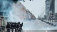 PM militarized police personnel in riot gear fire tear gas at protestors blocking the road before the long-distance bus terminal during the nationwide strike called by unions opposing austerity reforms in Rio de Janeiro, Brazil, on April 28, 2017. / AFP.